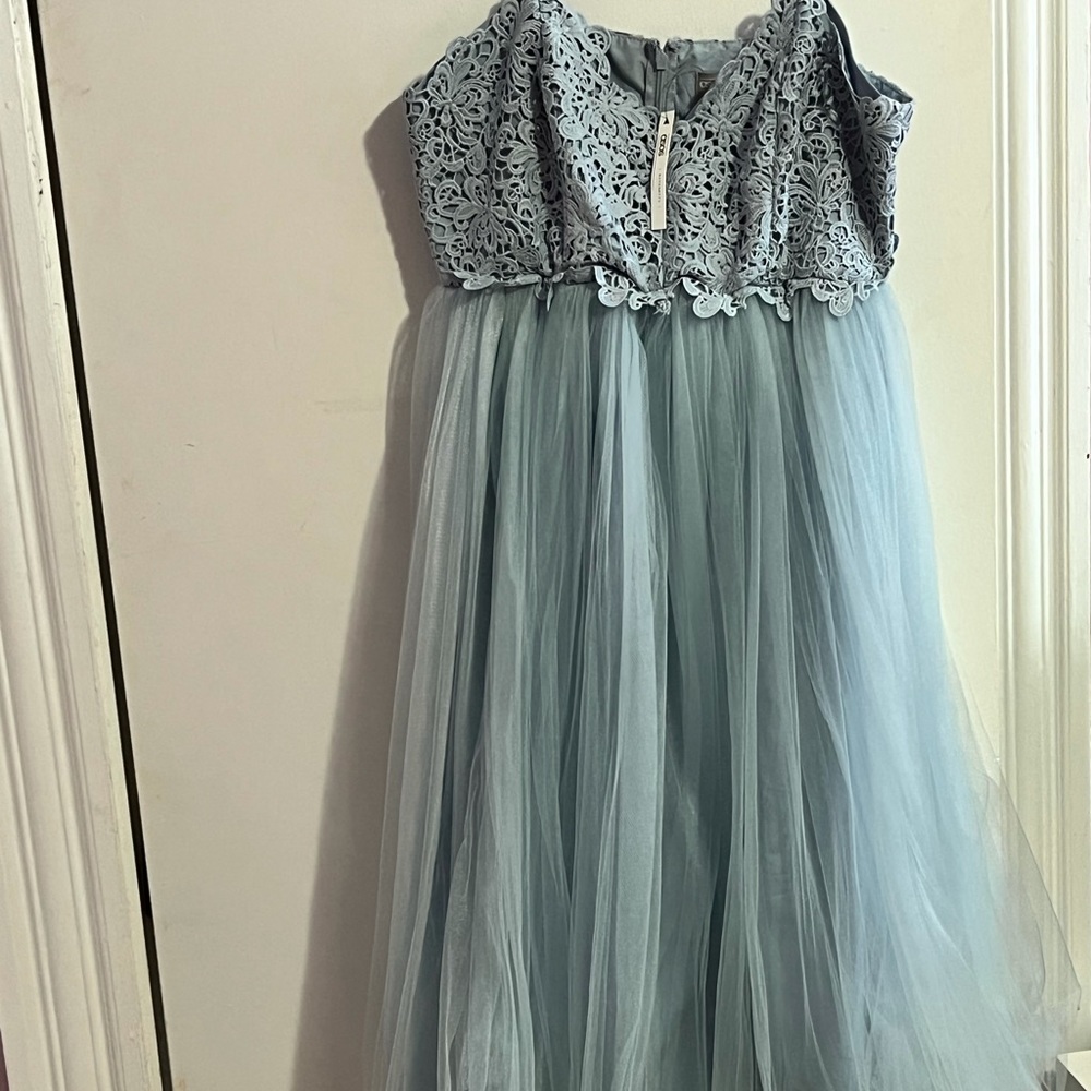 Light blue dress with beautiful patterns on front and back .